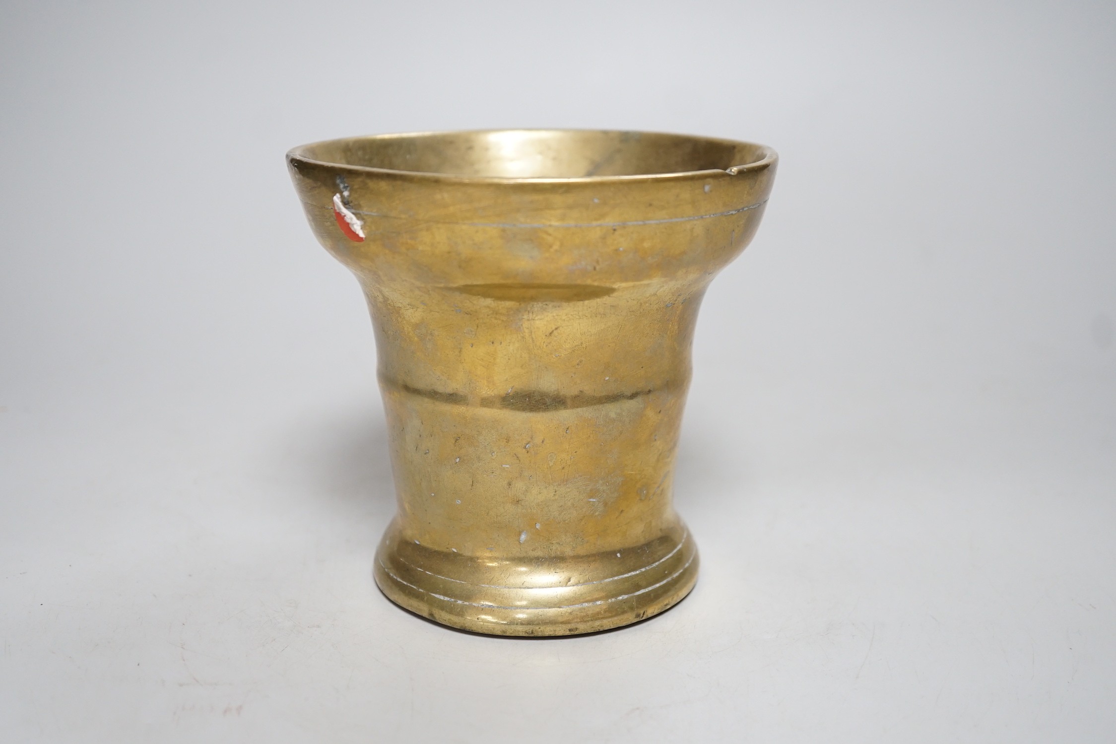 A 17th century bronze mortar. 12cm tall